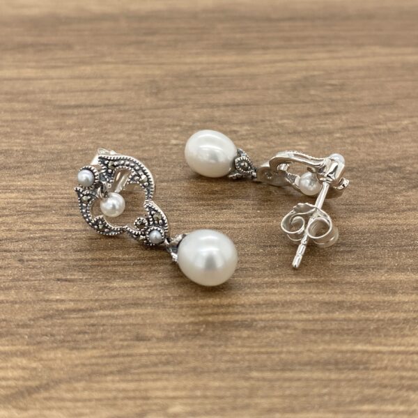 Silver pearl earrings with marcasite accents.