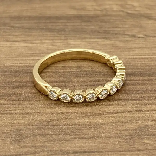 Gold band with bezel set diamonds.