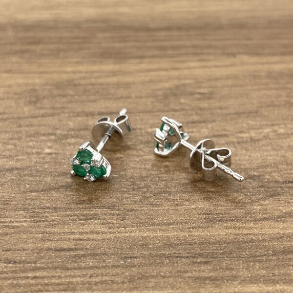 Emerald and diamond stud earrings.