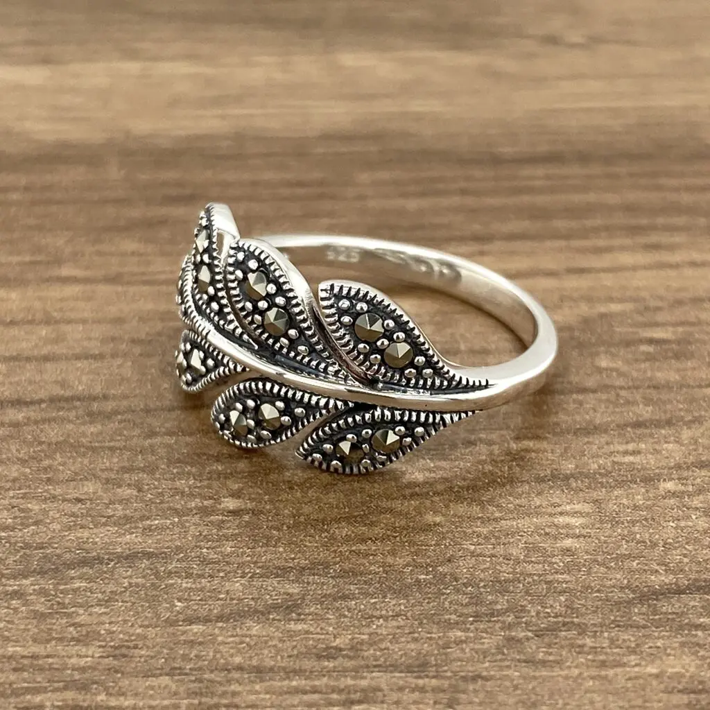 Silver ring with a leaf design and marcasite stones.