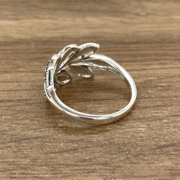 Silver ring with floral design.