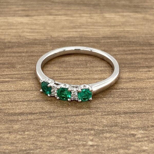 White gold ring with emerald gemstones.