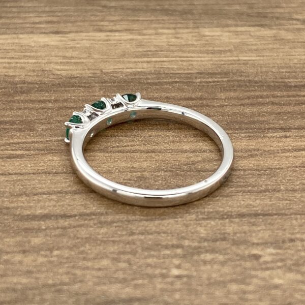 Silver ring with green gemstones.