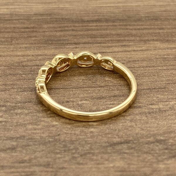 A yellow gold ring with a diamond in the middle.