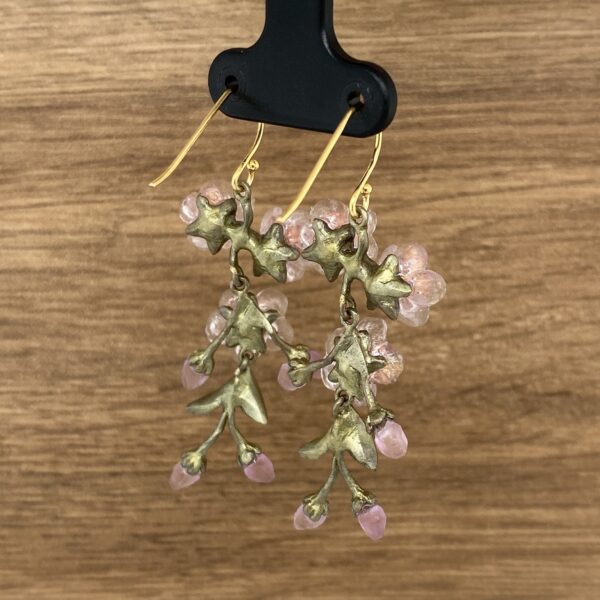 Gold floral dangle earrings with pink beads.