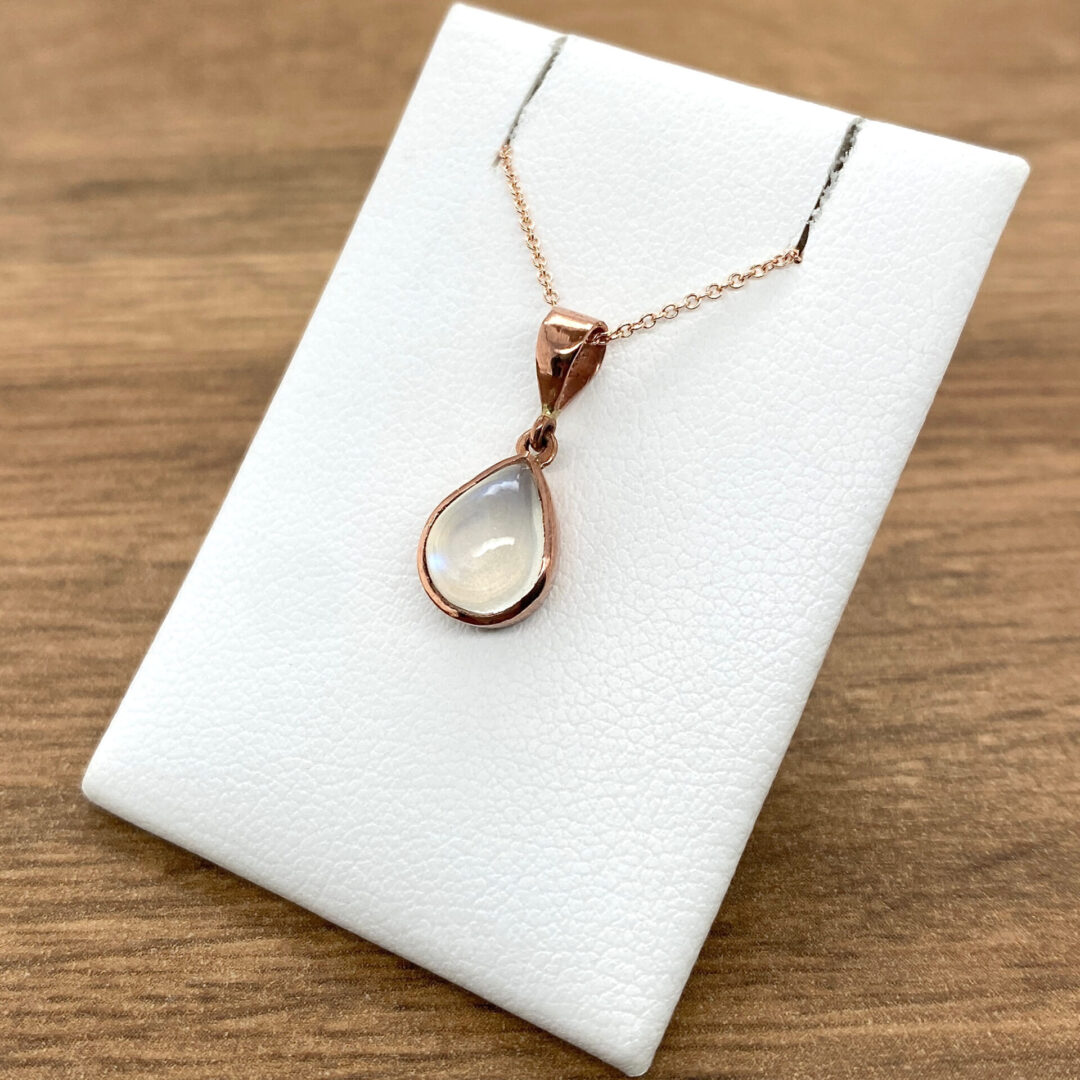 Rose gold necklace with moonstone pendant.