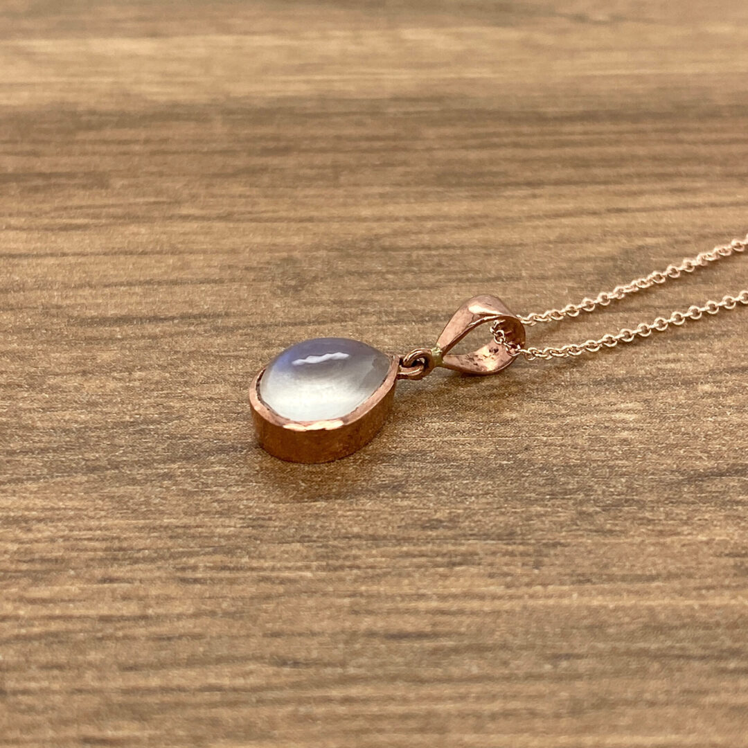 Rose gold necklace with moonstone pendant.