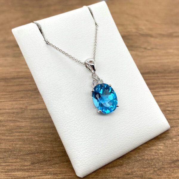 Blue topaz pendant necklace on display.