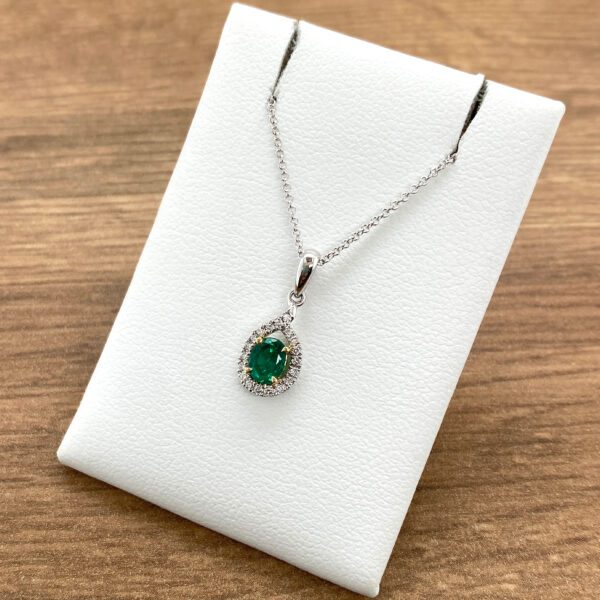 Emerald and diamond pendant necklace.