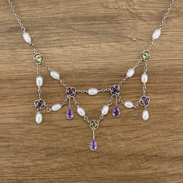 Amethyst and pearl necklace with green accents.