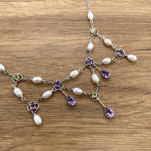 Silver necklace with pearls and gemstones.