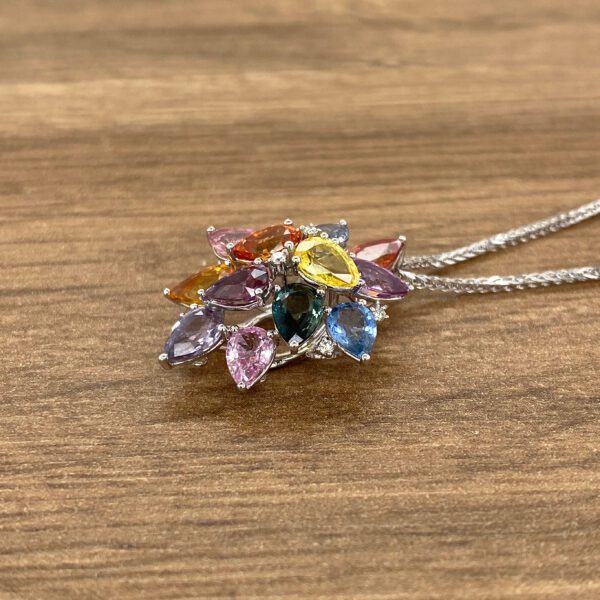 Multicolored gemstone pendant necklace on wood.