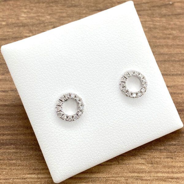 Diamond circle stud earrings on white background.