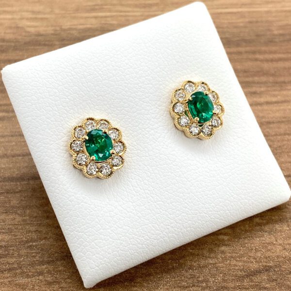 Emerald and diamond floral earrings.