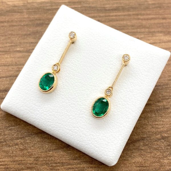 Emerald and diamond drop earrings.