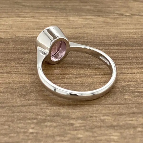 Silver ring with pink gemstone.