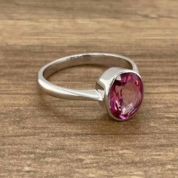 Silver ring with pink gemstone.