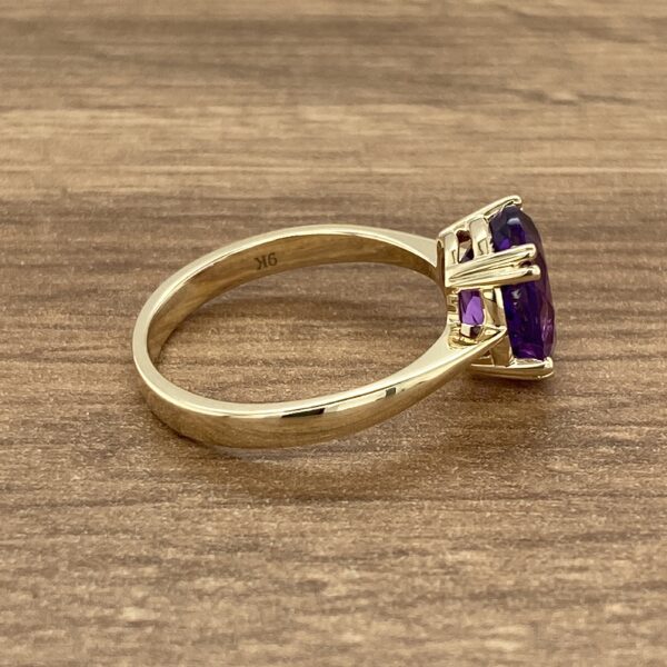 Gold ring with a large amethyst stone.