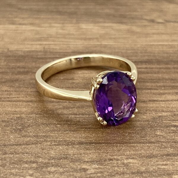 Gold ring with a large amethyst stone.