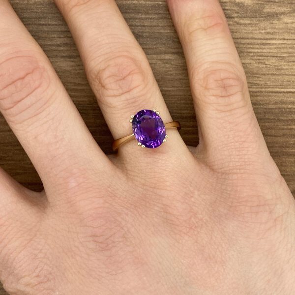 Gold ring with a large amethyst stone.