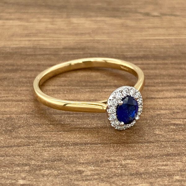 Gold ring with blue sapphire and diamonds.
