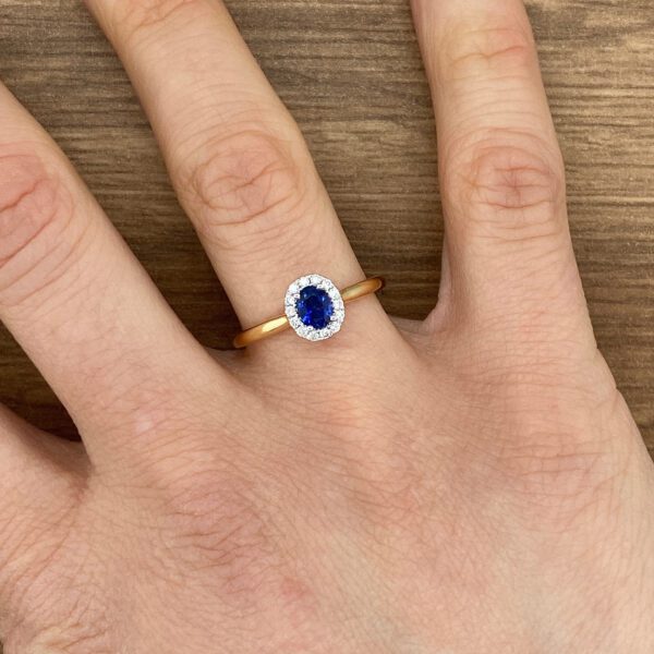 Gold ring with a blue sapphire and diamonds.
