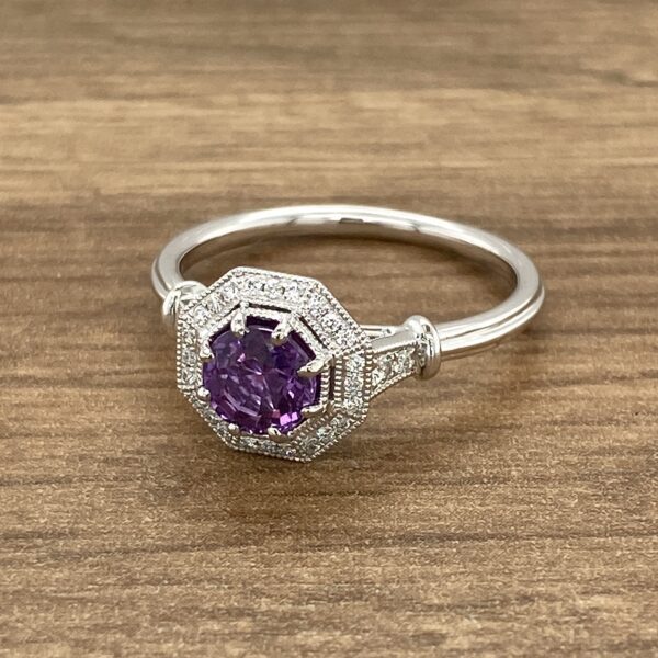 Diamond ring with purple gemstone.