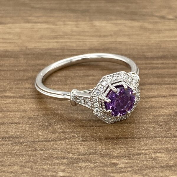 Diamond ring with purple gemstone.