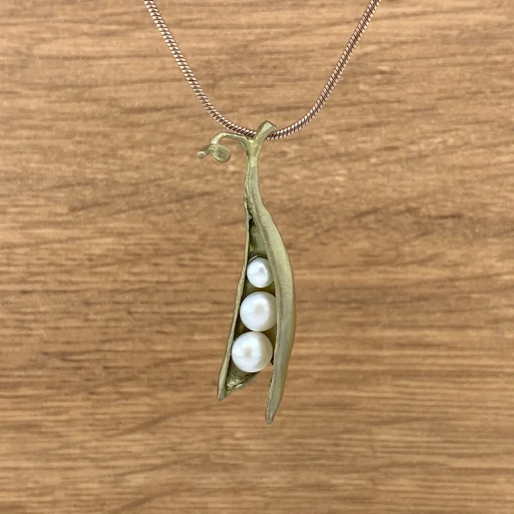 Peapod pendant with pearl necklace.