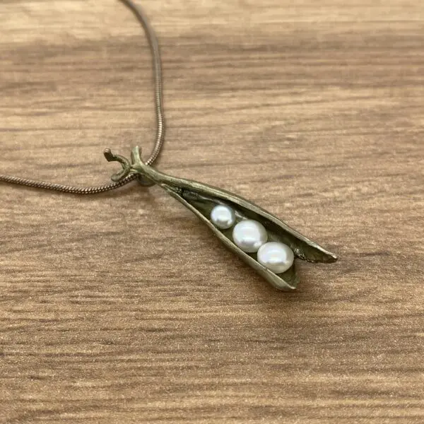 Silver pea pod necklace with pearls.