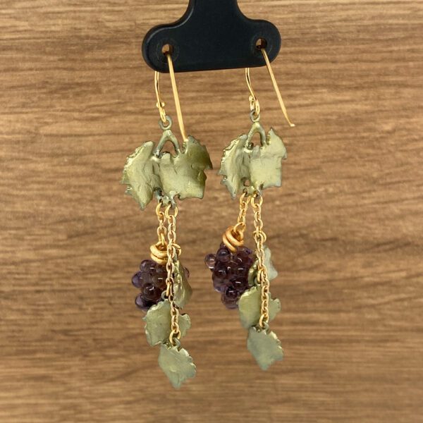 Gold earrings with grape clusters and leaves.