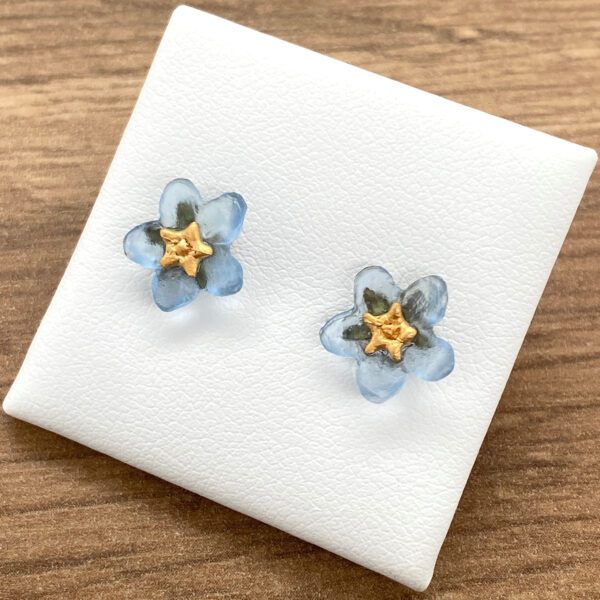 Pair of blue flower earrings with gold centers.