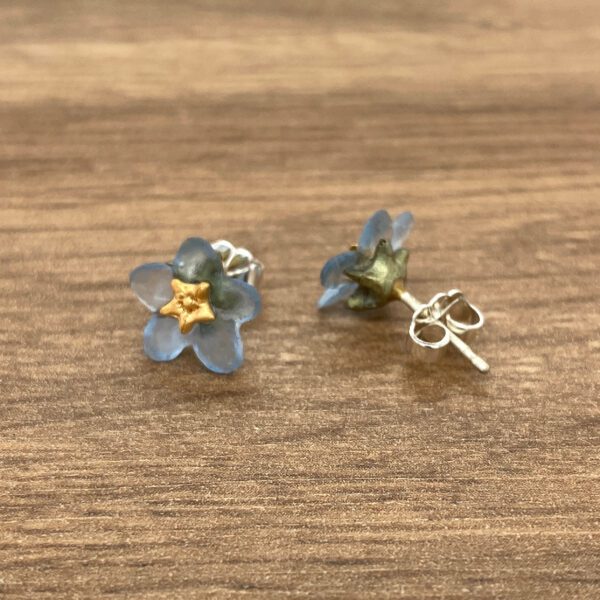 Pair of blue flower earrings with gold center.