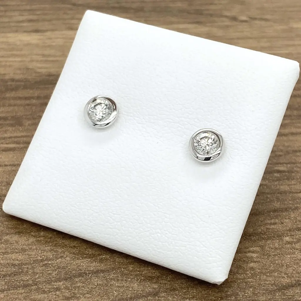 Pair of diamond bezel set stud earrings.