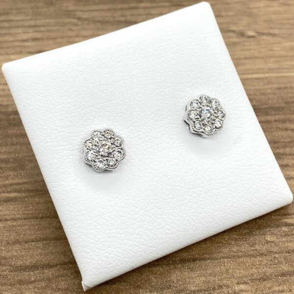 Pair of diamond flower stud earrings.