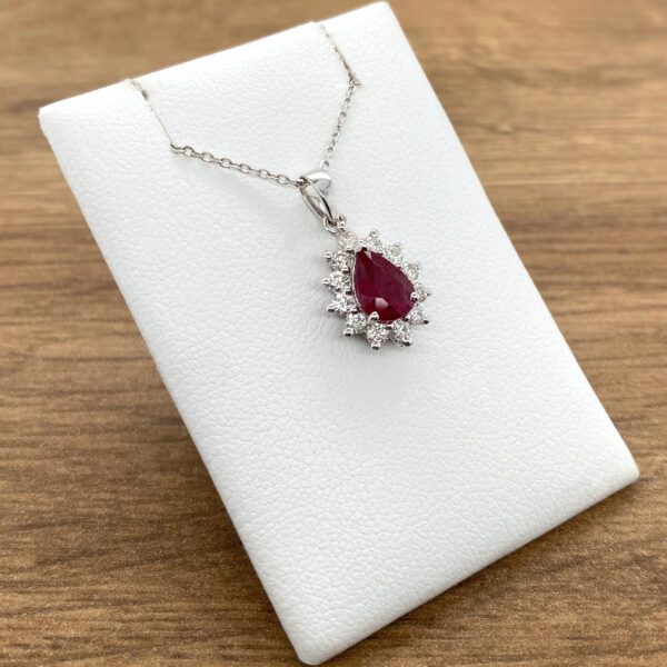 Ruby and diamond pendant necklace on display.