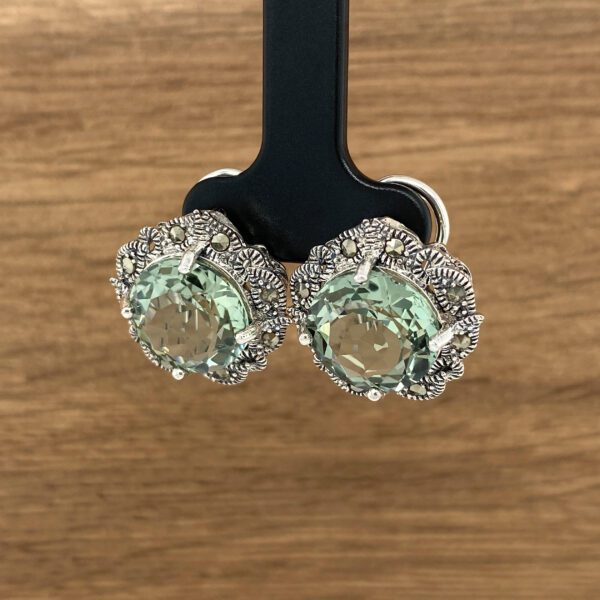 Green gemstone earrings with silver accents.