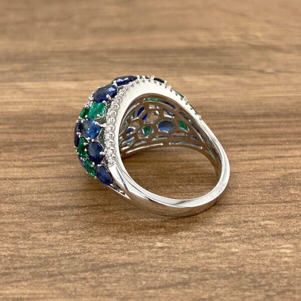 White gold ring with emerald and sapphire stones.