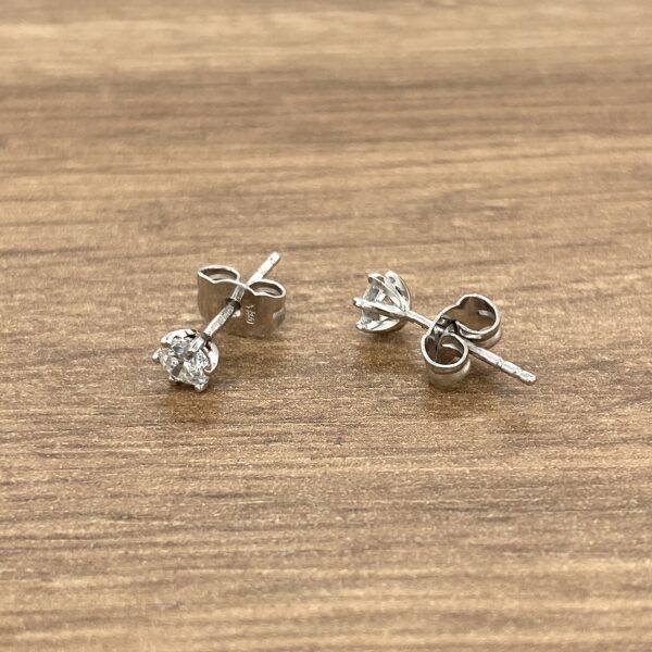 Silver stud earrings with clear stones.