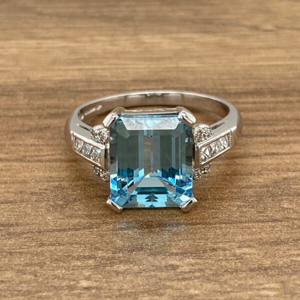 A large blue topaz ring with diamonds.