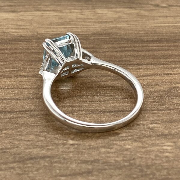 Silver ring with blue gemstone.