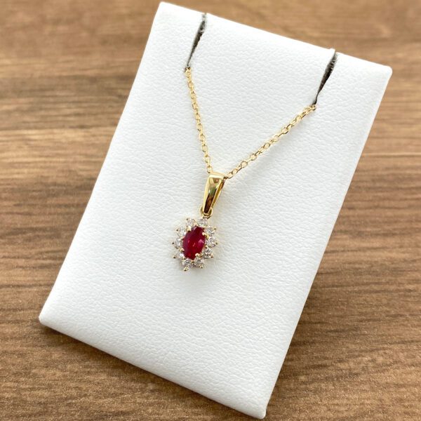 Gold necklace with ruby and diamond pendant.