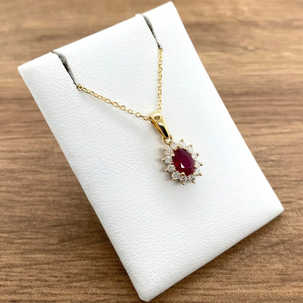 Gold necklace with ruby and diamond pendant.