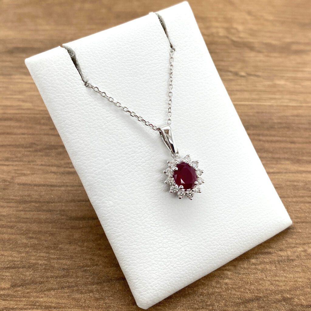 Ruby and diamond pendant necklace on display.