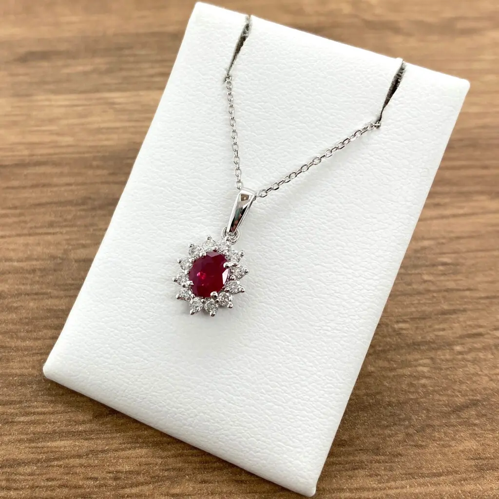 Ruby and diamond pendant necklace on display.