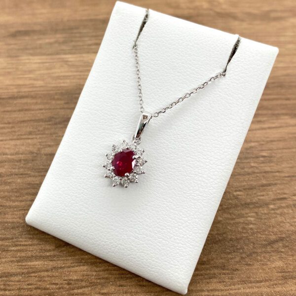 Ruby and diamond pendant necklace on display.