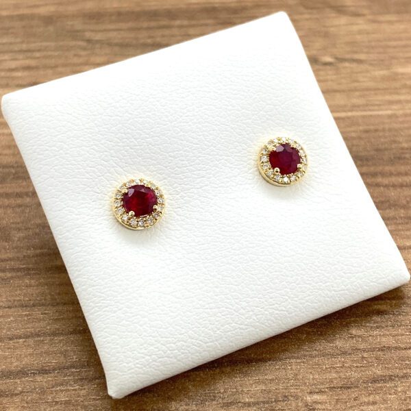 Gold ruby earrings with diamond halo.