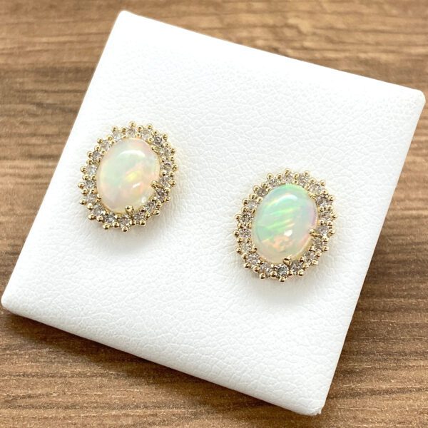 Gold opal earrings with diamond halo.