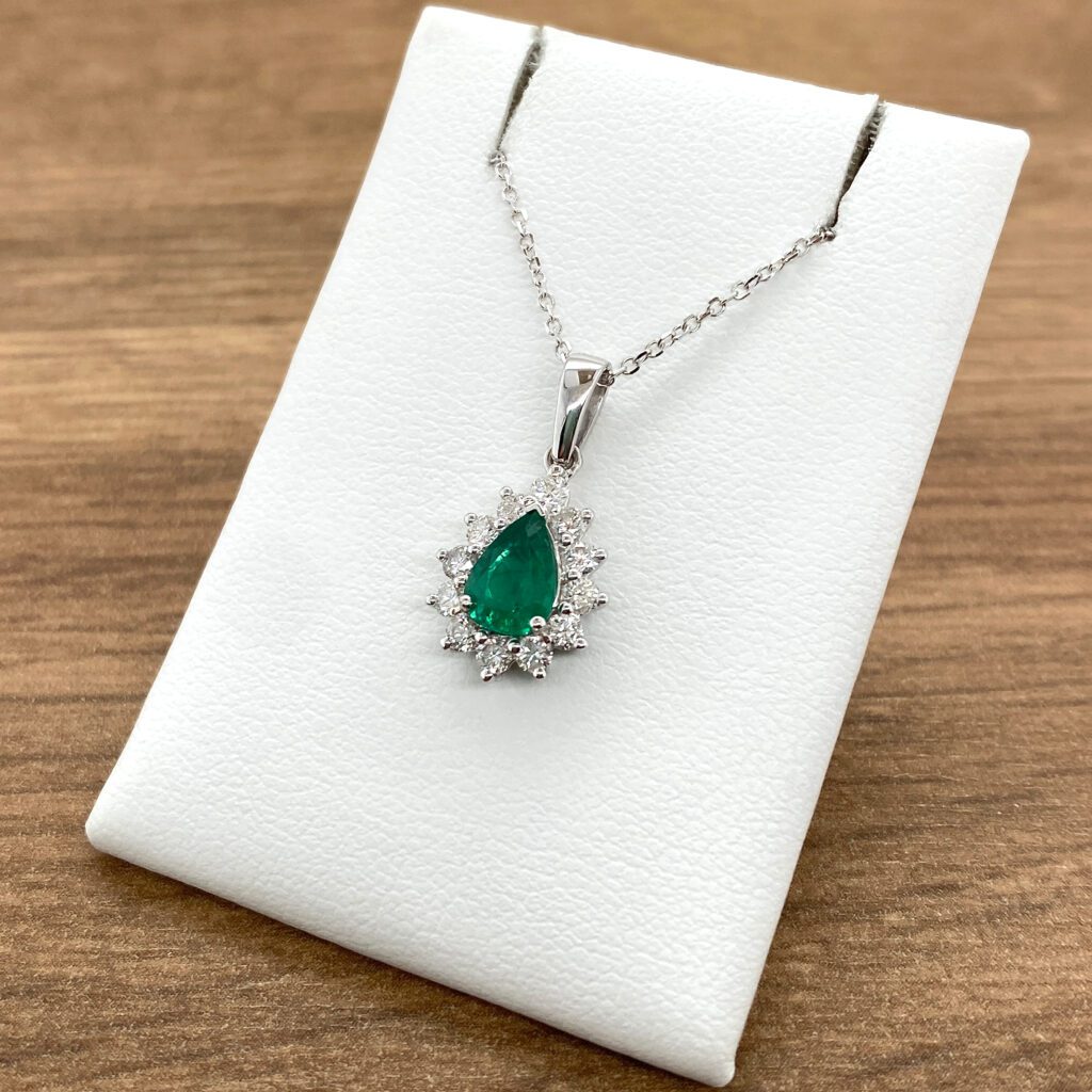 Emerald and diamond pendant necklace.