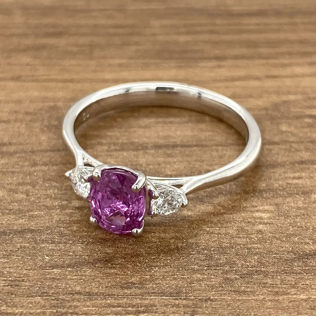 White gold ring with pink sapphire and diamonds.